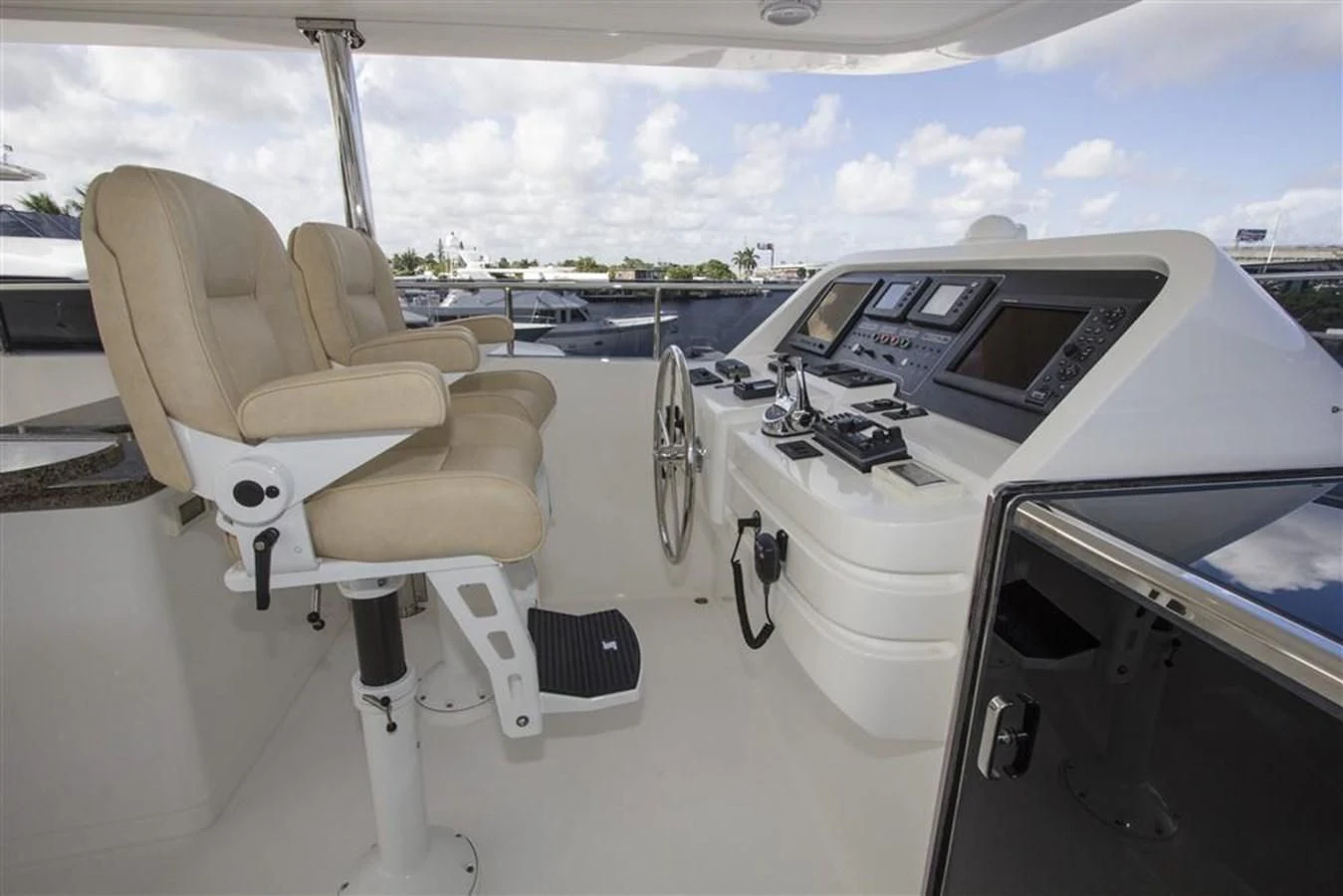 a white car with a seat and a steering wheel on a boat aboard EBITDA Yacht for Sale