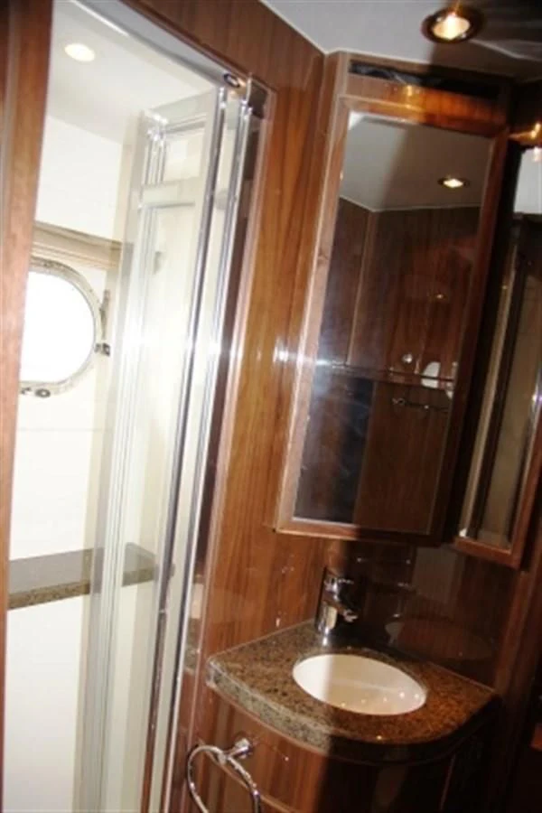 a bathroom with a sink and a mirror aboard EBITDA Yacht for Sale