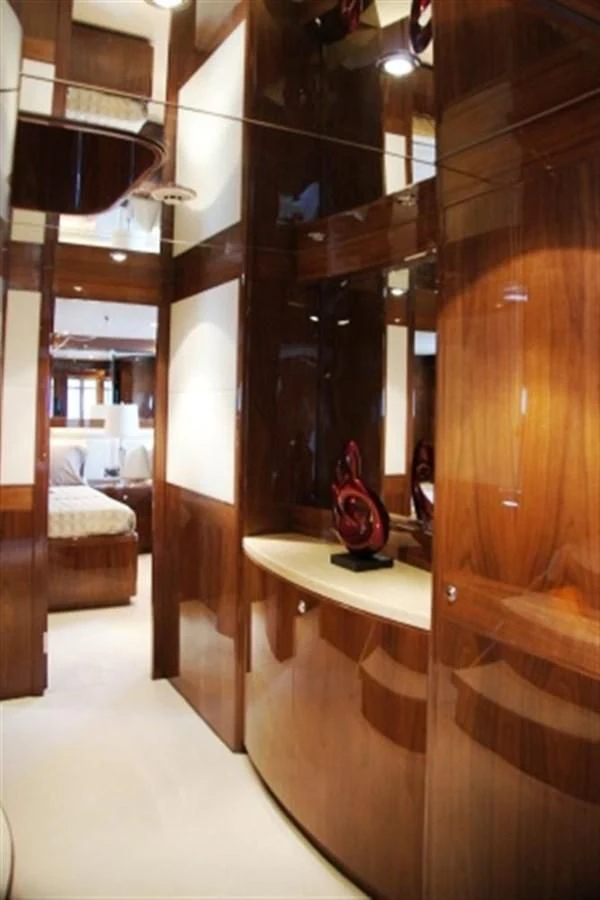 a room with a wood cabinet and a bed aboard EBITDA Yacht for Sale