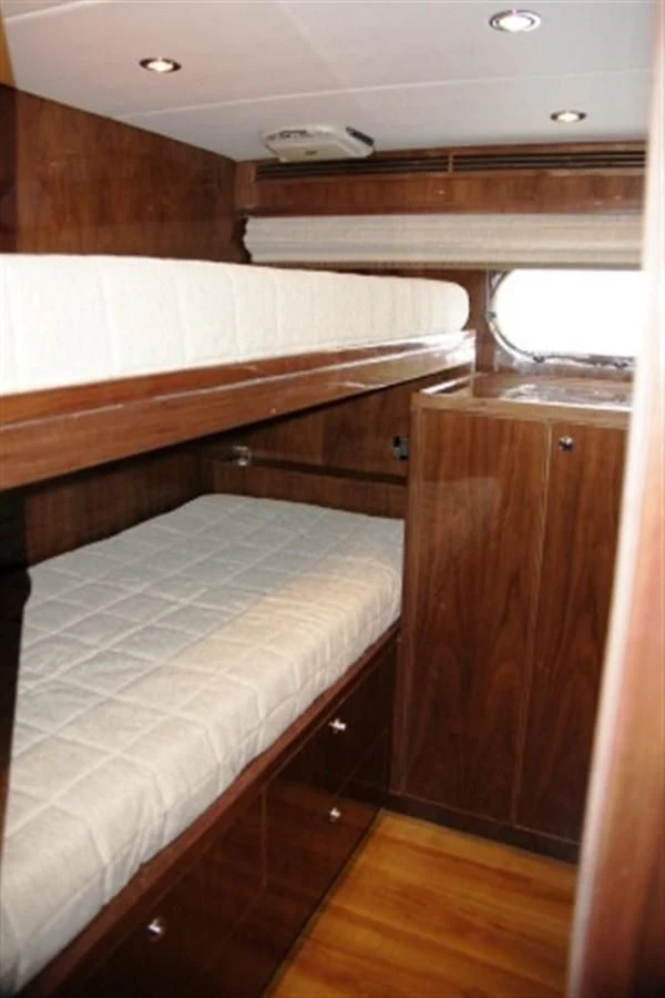 a room with a bed and a desk aboard EBITDA Yacht for Sale