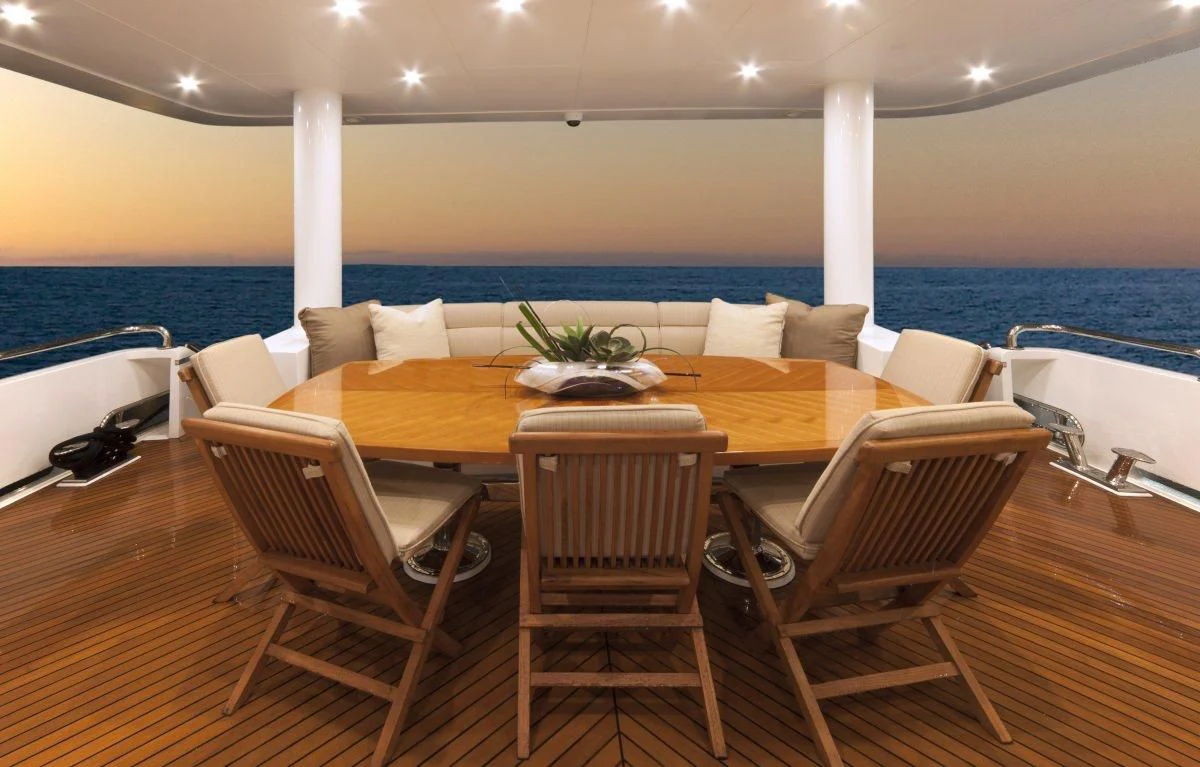 a table with chairs around it aboard EBITDA Yacht for Sale