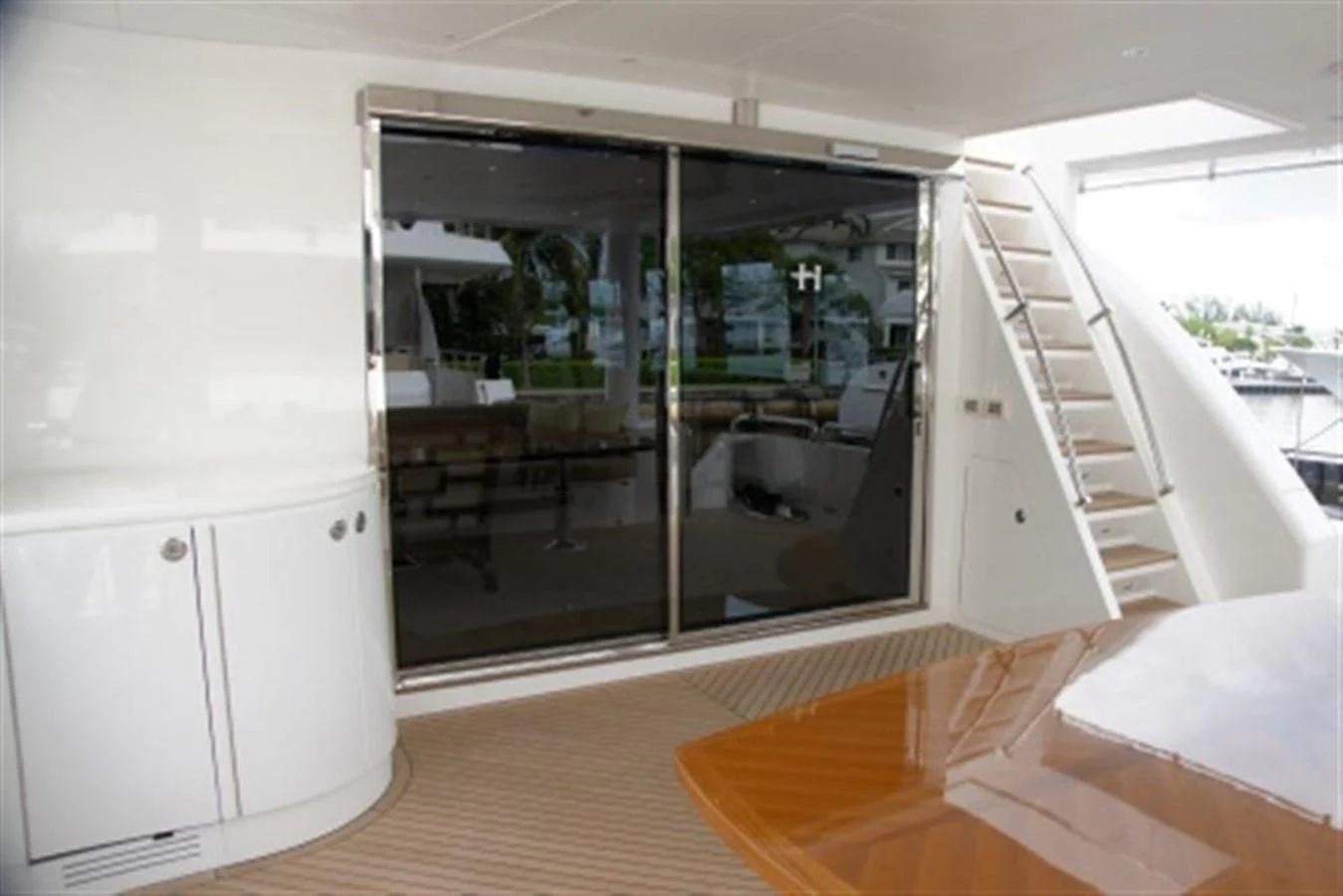 a room with a glass door aboard EBITDA Yacht for Sale