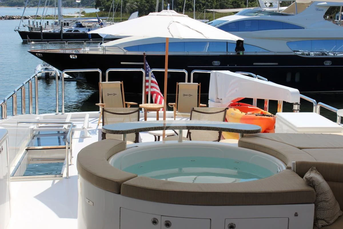 a boat with chairs and umbrellas aboard EBITDA Yacht for Sale