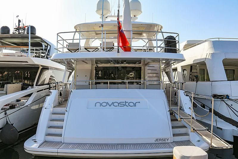 a boat with a flag on the front aboard NOVASTAR Yacht for Sale