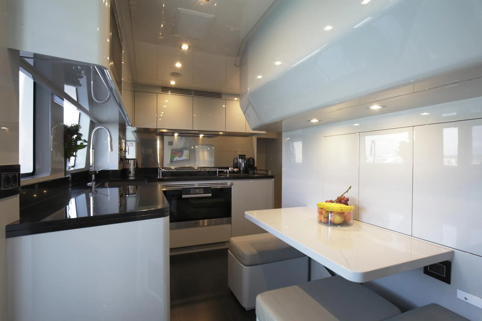 a kitchen with white cabinets aboard NOVASTAR Yacht for Sale