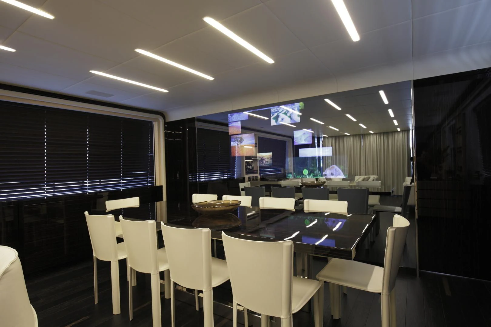 a room with tables and chairs aboard NOVASTAR Yacht for Sale
