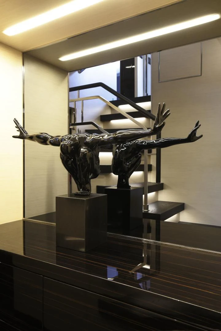 a statue of a person in a room with a mirror aboard NOVASTAR Yacht for Sale