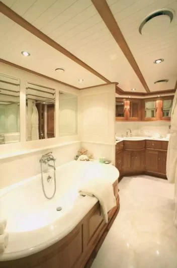 a bathroom with a bathtub and sink aboard PITUXIN VI Yacht for Sale