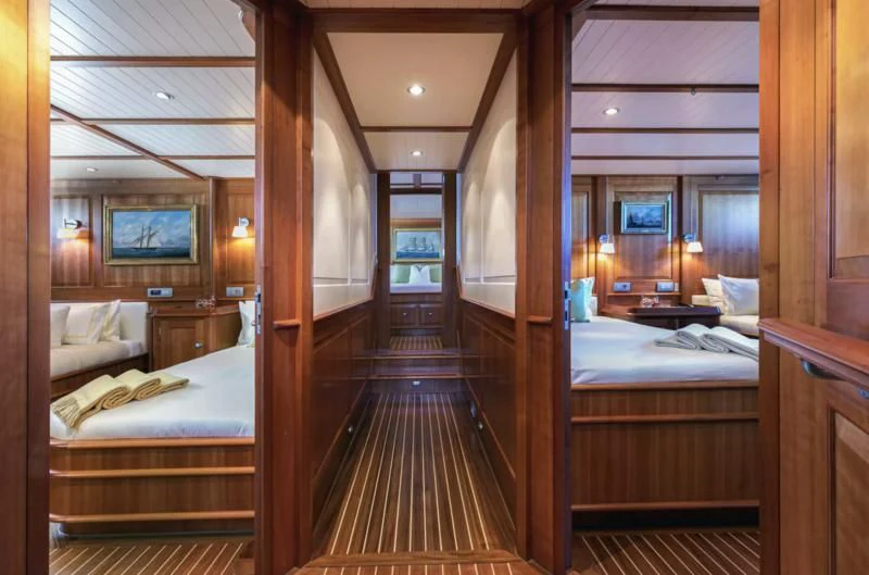 a room with a bed and a television on the wall aboard PITUXIN VI Yacht for Sale