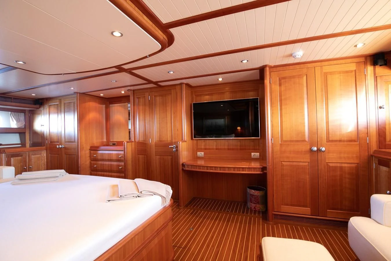 a room with a bed and a television aboard PITUXIN VI Yacht for Sale
