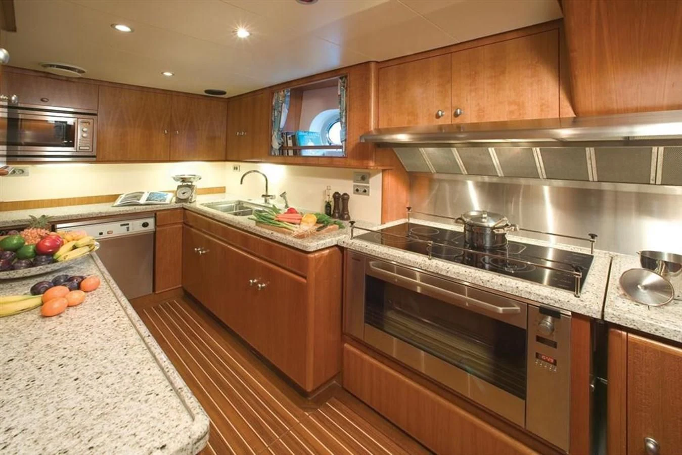 a kitchen with wooden cabinets aboard PITUXIN VI Yacht for Sale