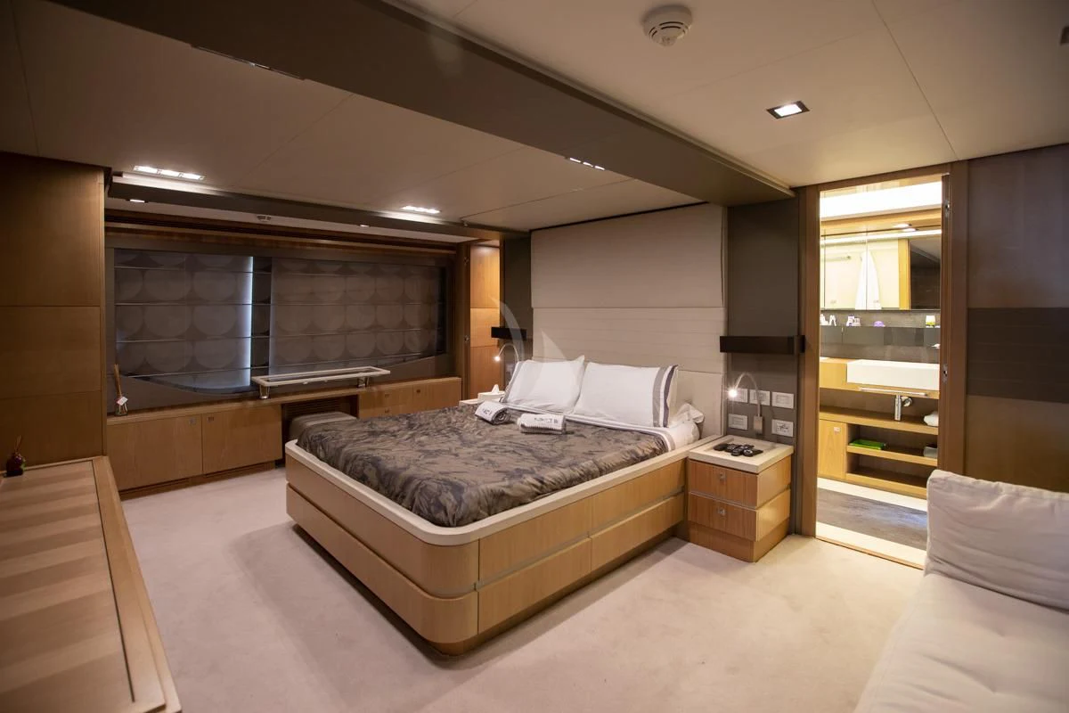 a large bedroom with a bed aboard NIKO III Yacht for Charter