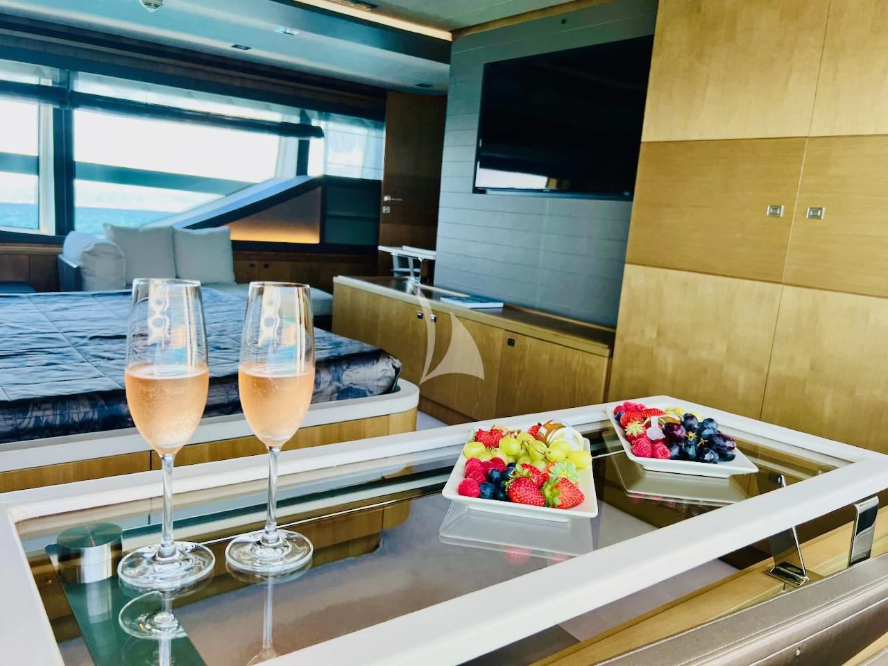 a table with wine glasses and food on it aboard NIKO III Yacht for Charter