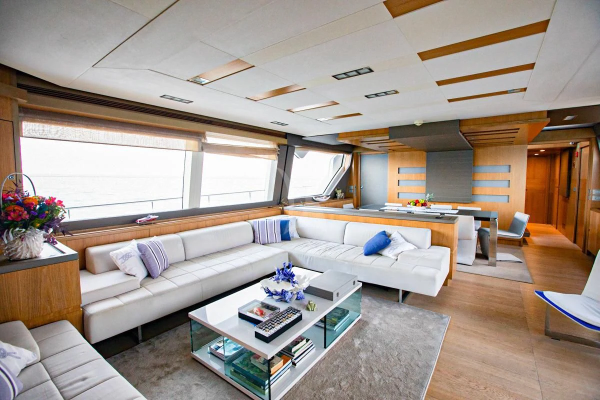 a living room with a couch and a coffee table aboard NIKO III Yacht for Charter