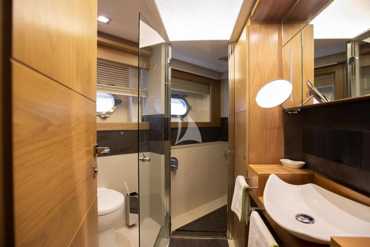 a bathroom with a glass shower aboard NIKO III Yacht for Charter