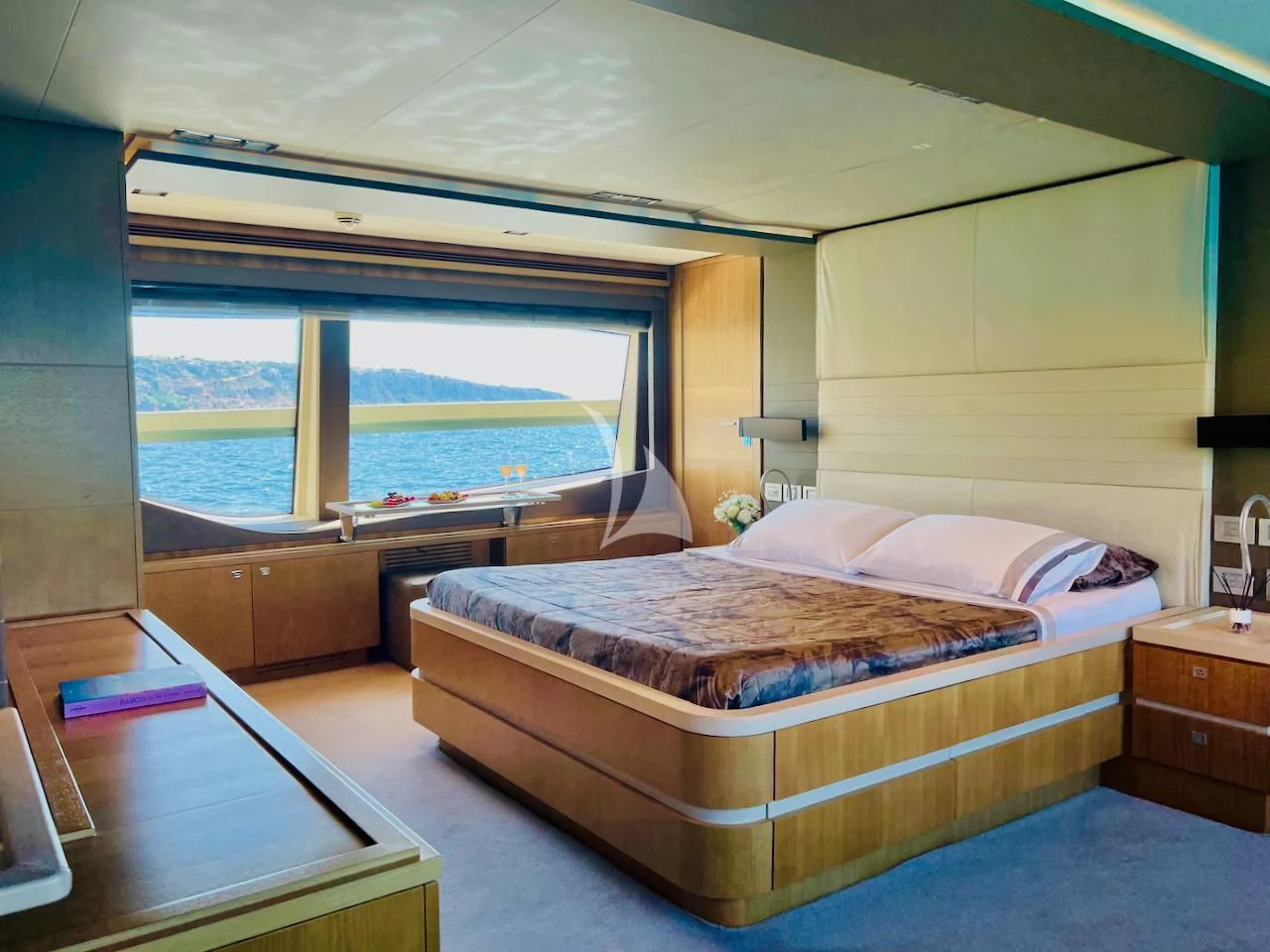 a bedroom with a large bed aboard NIKO III Yacht for Charter