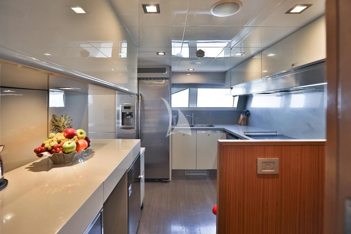 a kitchen with a large island aboard NIKO III Yacht for Charter