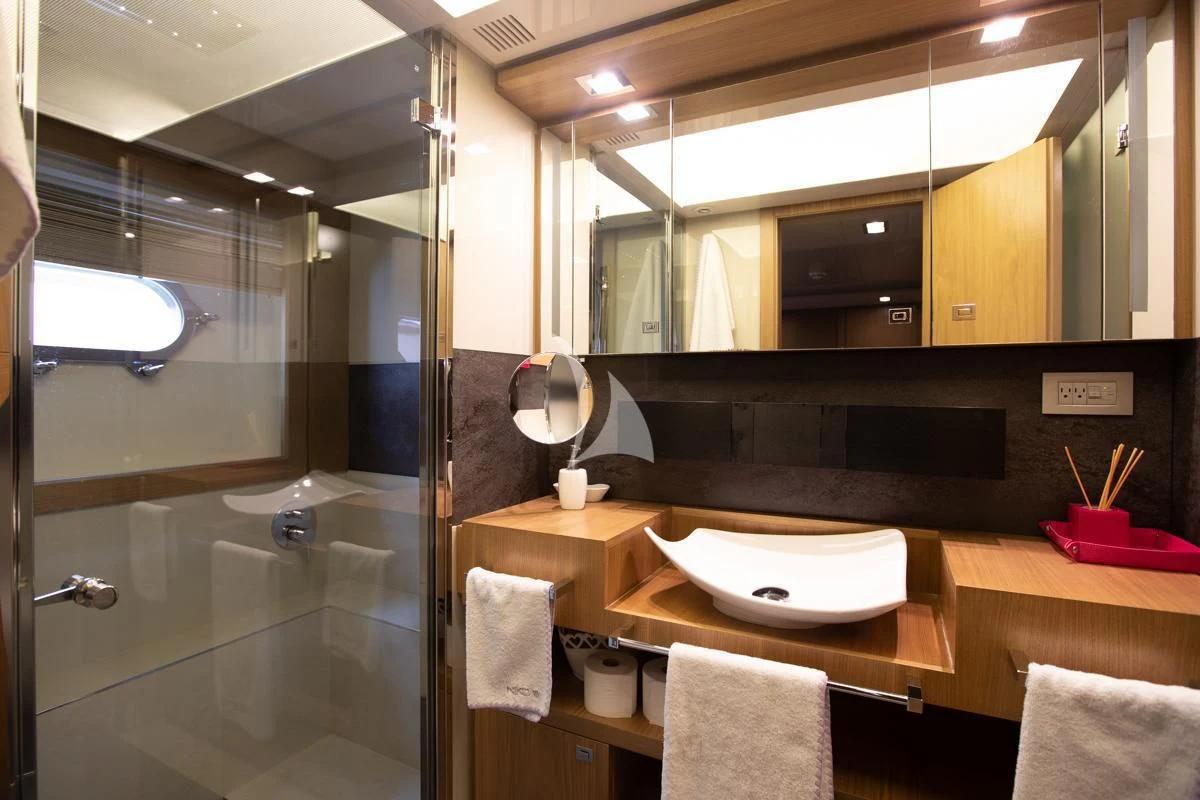 a bathroom with a large mirror aboard NIKO III Yacht for Charter