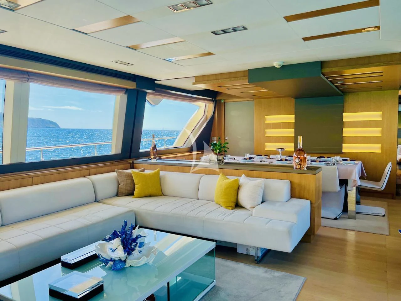 a living room with a couch and a table aboard NIKO III Yacht for Charter