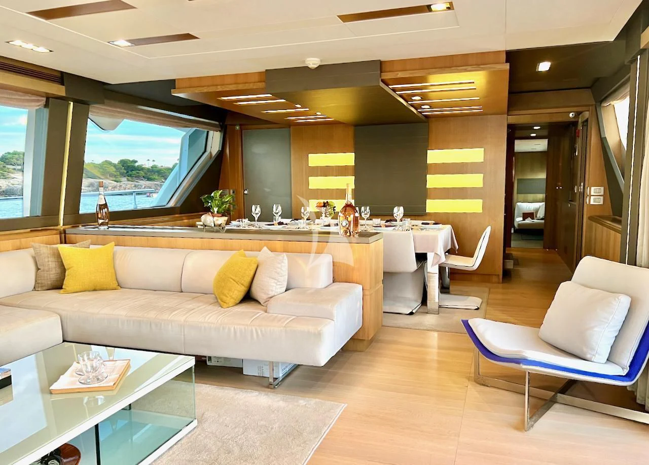 a living room with a couch and a table aboard NIKO III Yacht for Charter