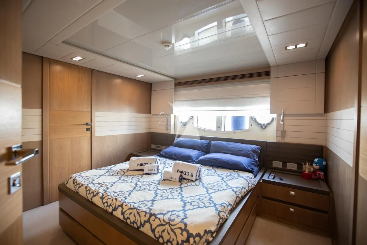 a bedroom with a bed aboard NIKO III Yacht for Charter
