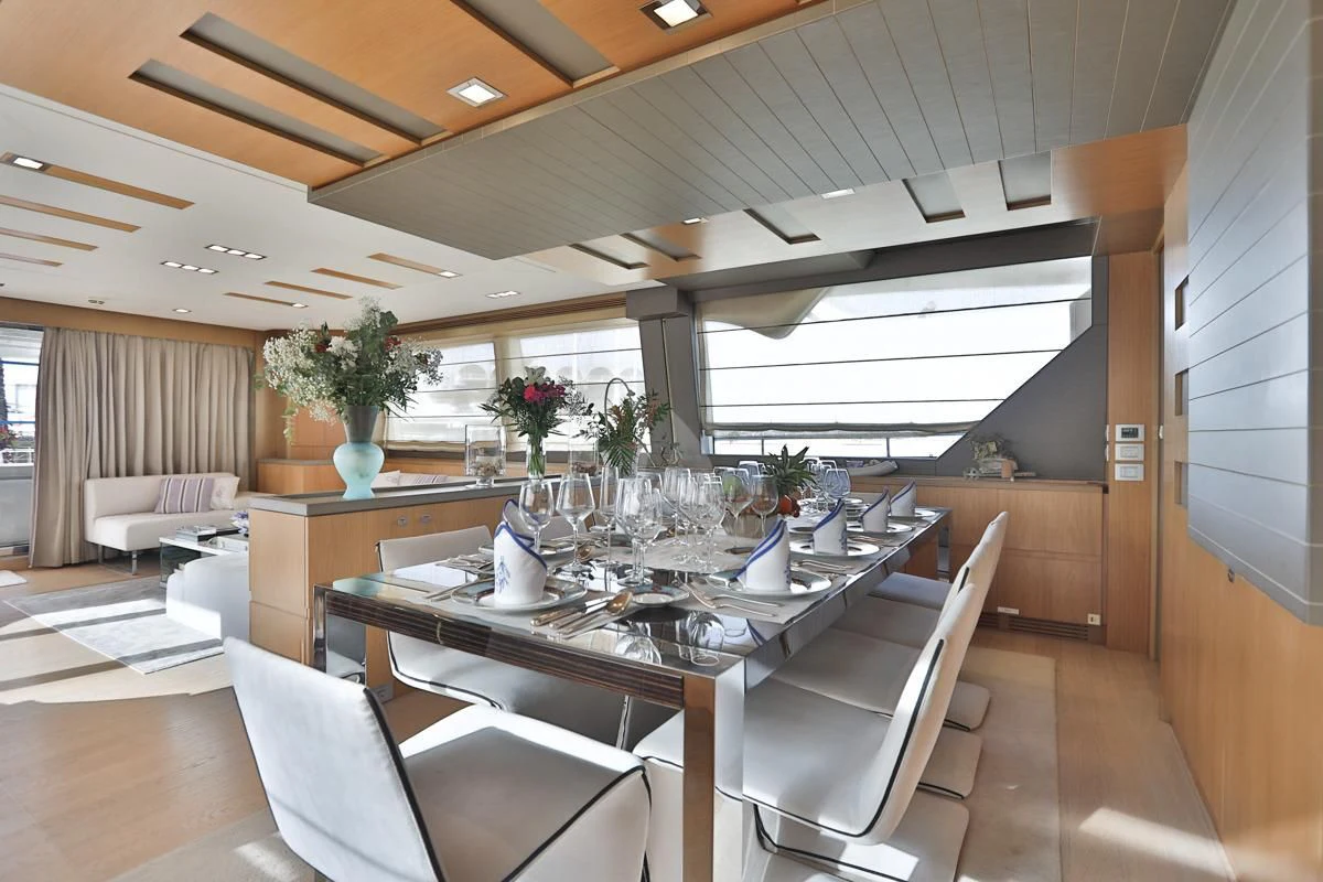 a dining table in a room aboard NIKO III Yacht for Charter