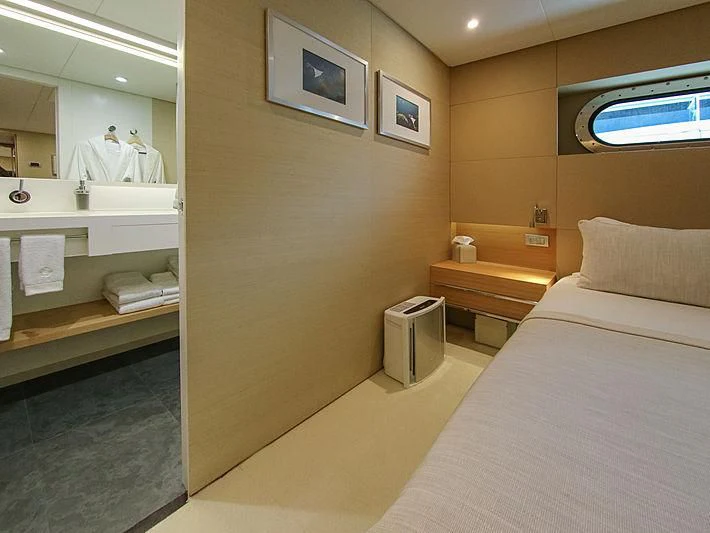 a room with a bed and a mirror aboard DARLING Yacht for Sale