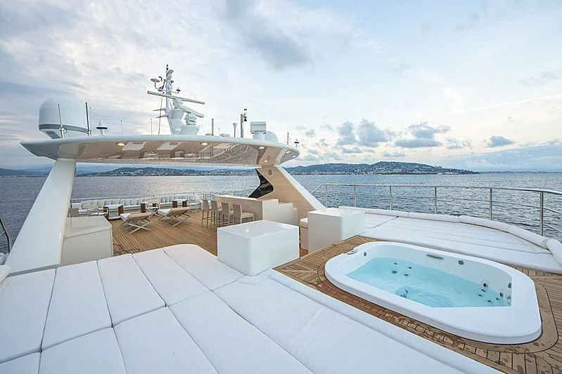 a large white boat with a large white pool in the middle of a large body of water with aboard DARLING Yacht for Sale