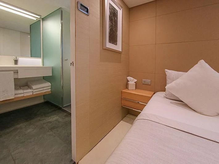 a bedroom with a bed and a mirror aboard DARLING Yacht for Sale