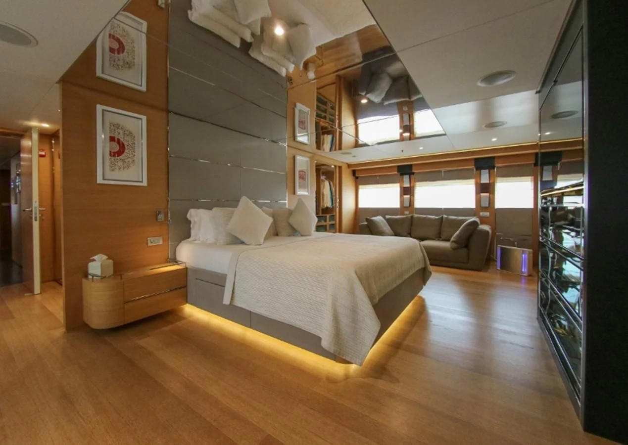 a room with a bed and a couch aboard DARLING Yacht for Sale