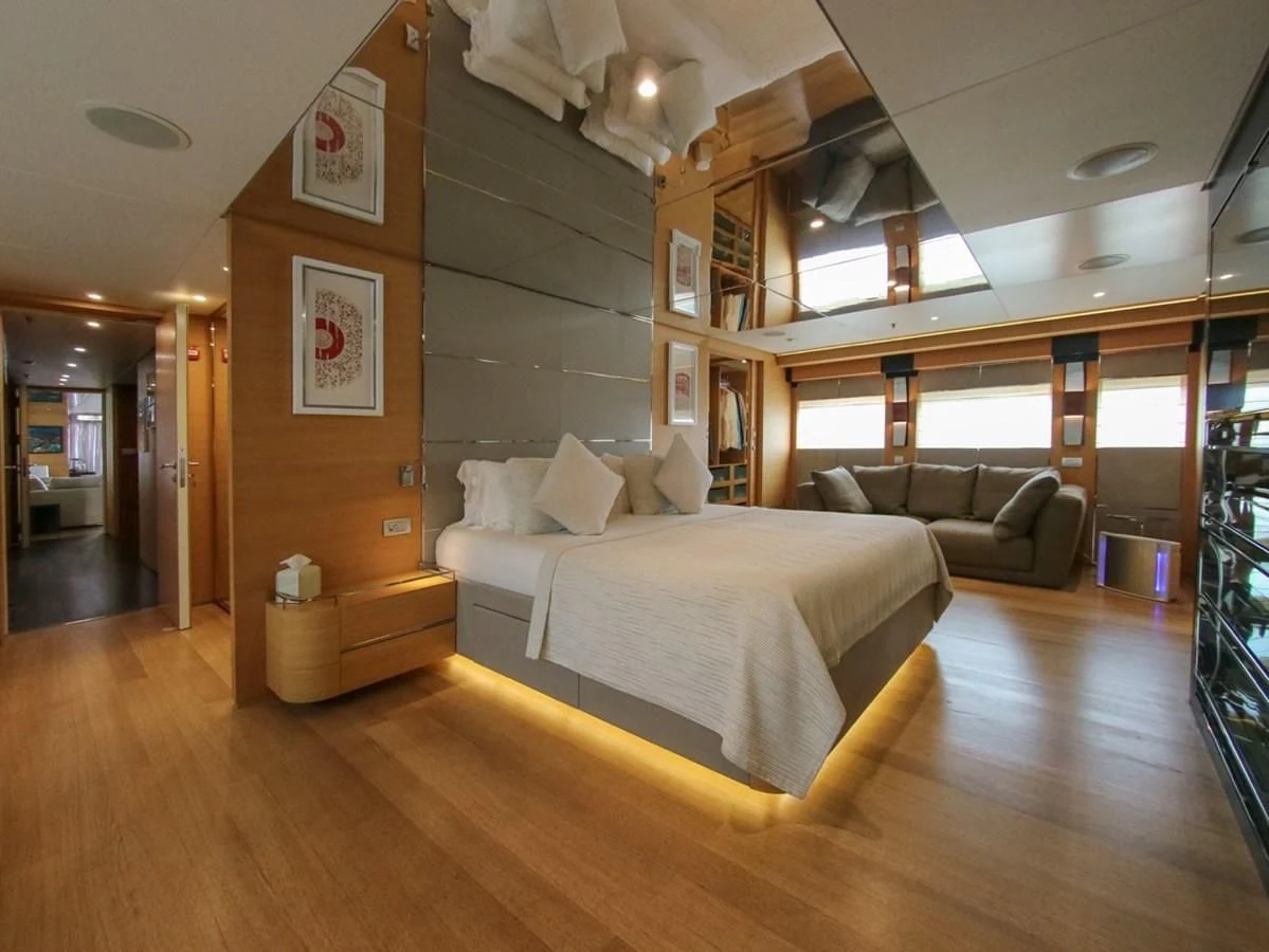 a room with a bed and a couch aboard DARLING Yacht for Sale