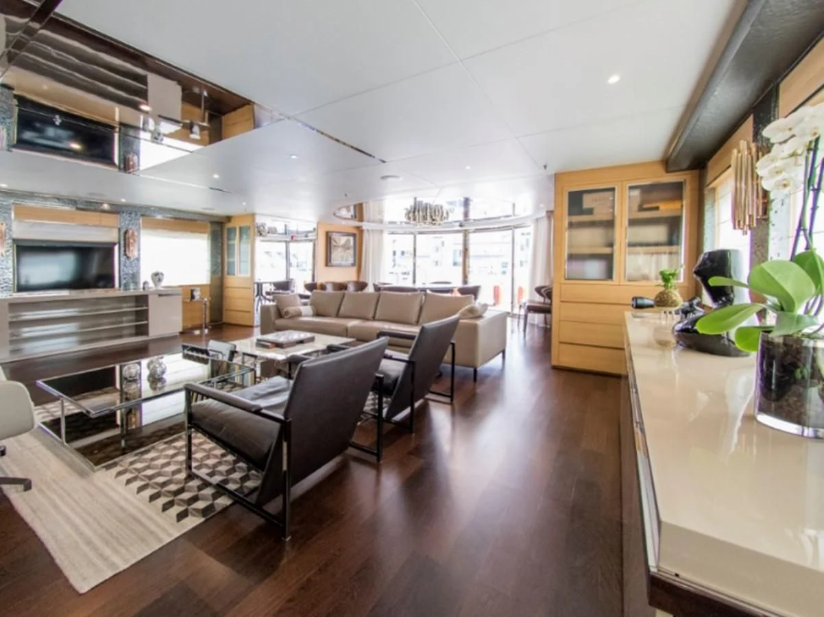 a living room with a kitchen and dining area aboard DARLING Yacht for Sale