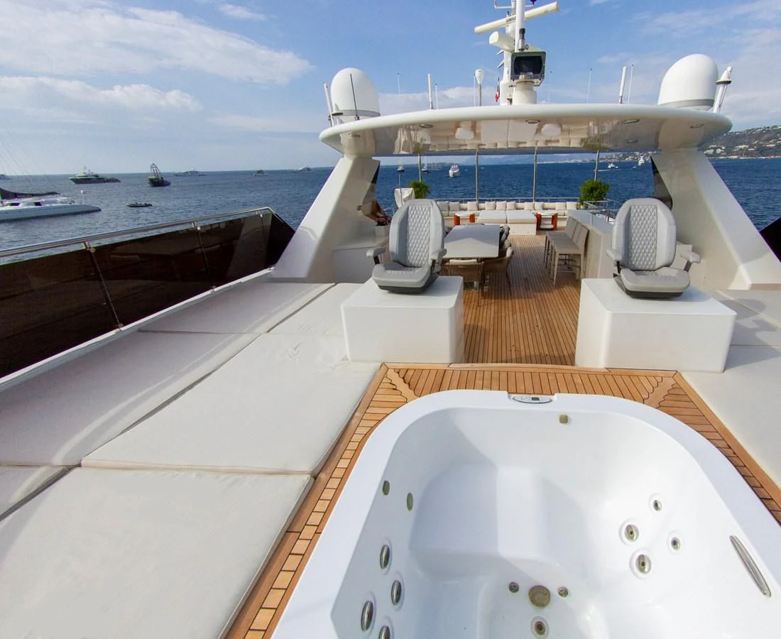 a deck of a boat and a large ship on the water aboard DARLING Yacht for Sale