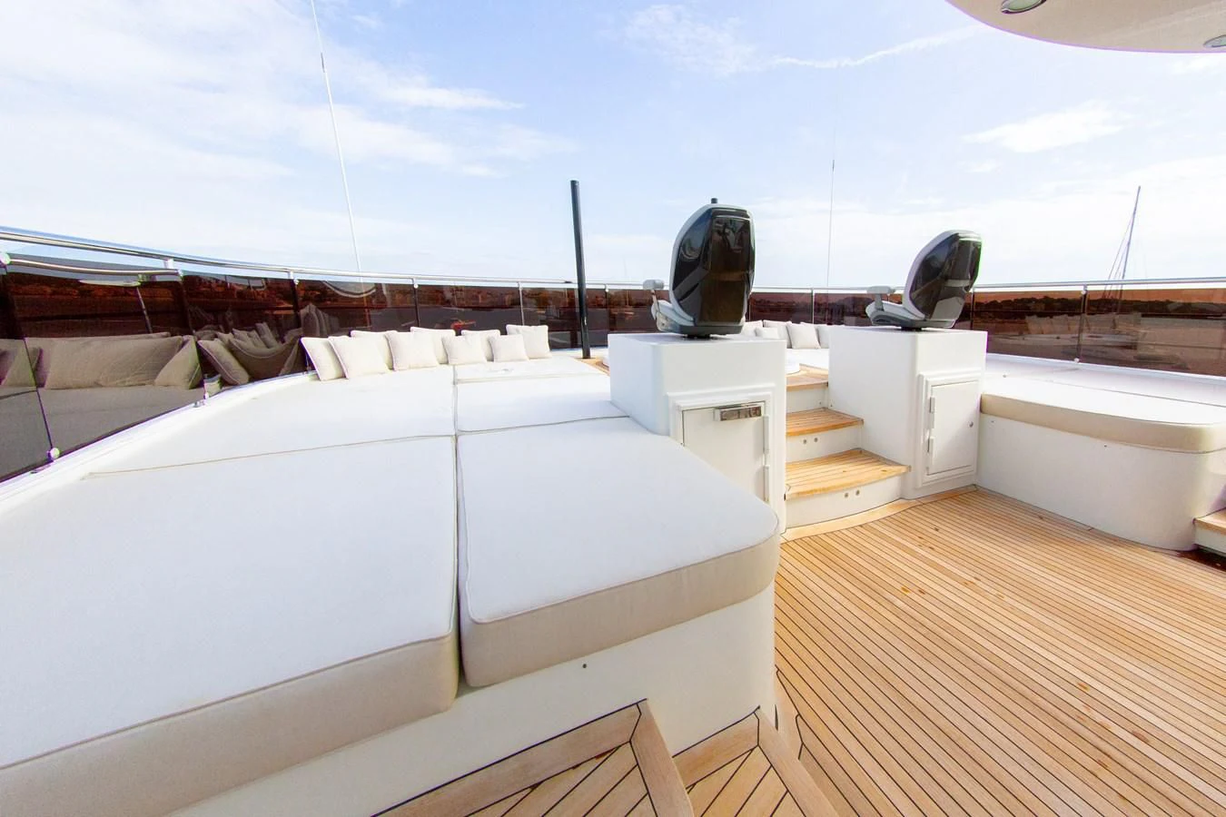 a room with a large bed and a large black chair on the roof aboard DARLING Yacht for Sale