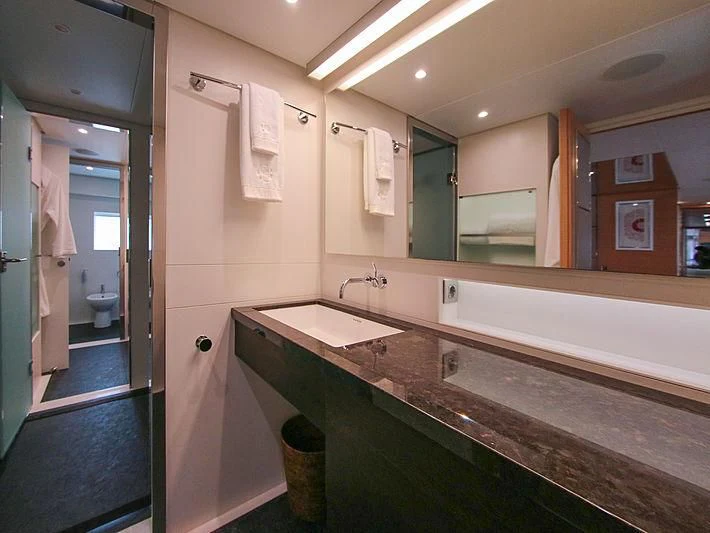 a bathroom with a countertop sink and a mirror aboard DARLING Yacht for Sale