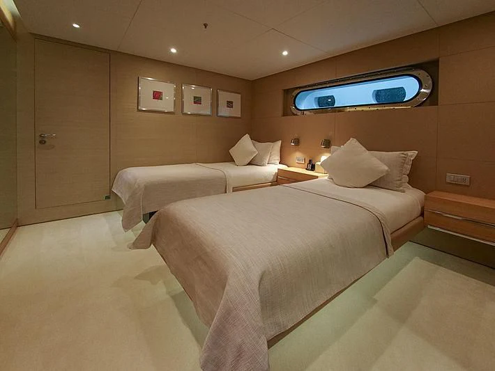 a room with a bed and a tv on the wall aboard DARLING Yacht for Sale