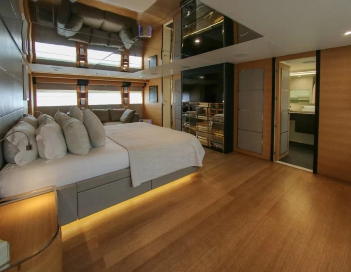 a room with a bed and a mirror aboard DARLING Yacht for Sale