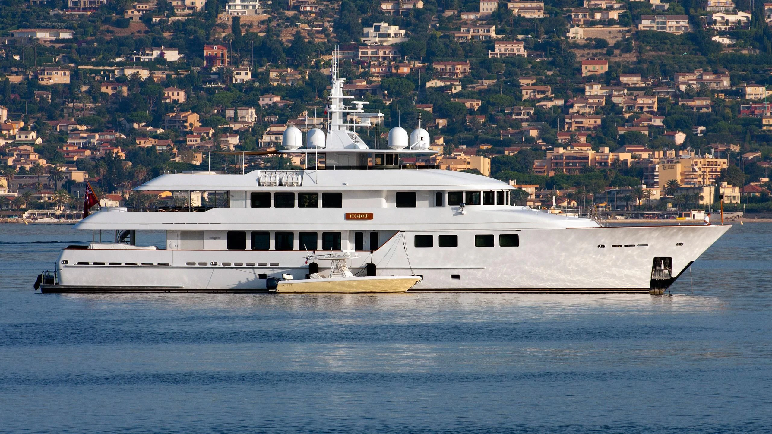 a large white ship in the water aboard INGOT Yacht for Sale