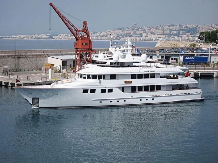 a large white boat in a harbor aboard INGOT Yacht for Sale