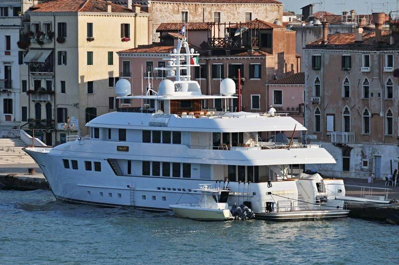 a large white boat on the water aboard INGOT Yacht for Sale