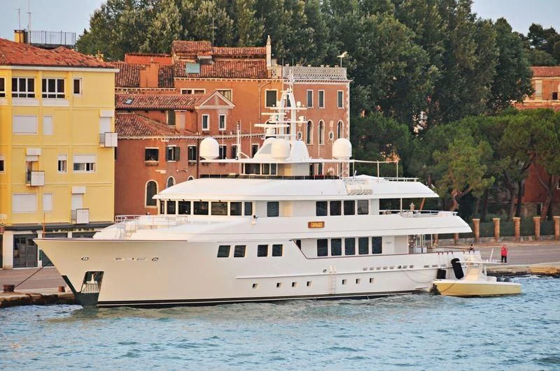 a large building next to a body of water aboard INGOT Yacht for Sale
