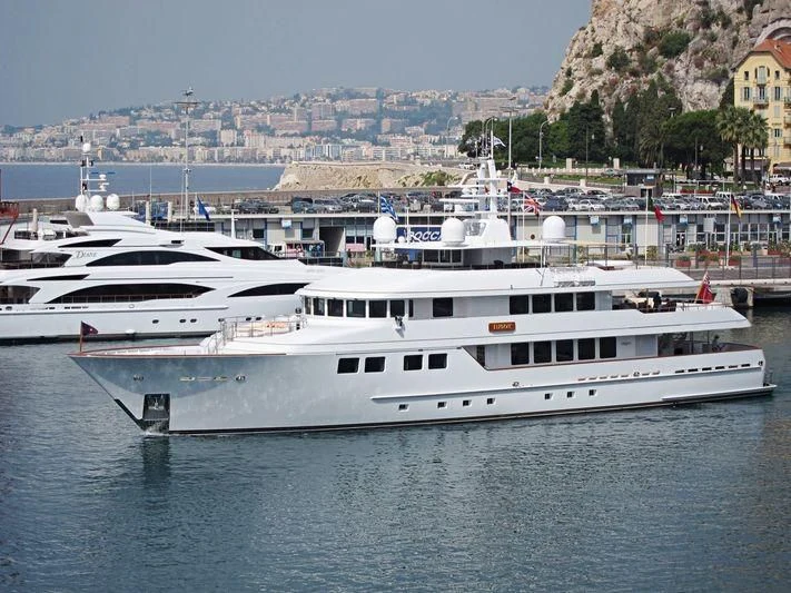 a couple of white yachts in the water aboard INGOT Yacht for Sale