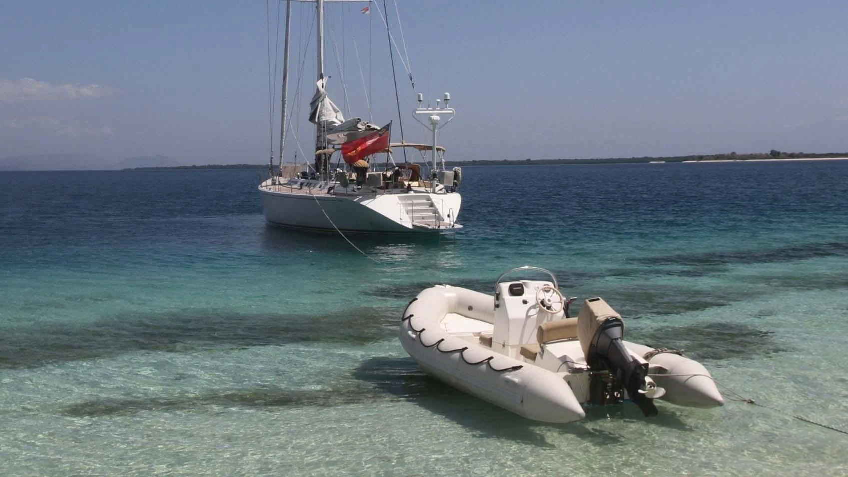 a boat and a motor boat in the water aboard DEIANEIRA Yacht for Sale