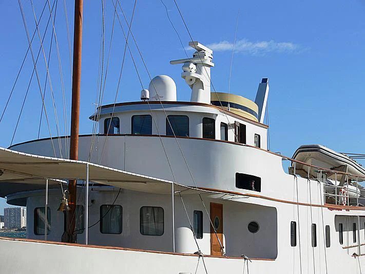 a white yacht with a blue sky aboard DEIANEIRA Yacht for Sale