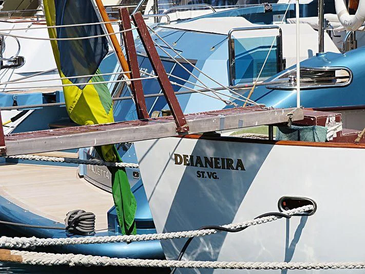 a boat with a flag on the front aboard DEIANEIRA Yacht for Sale