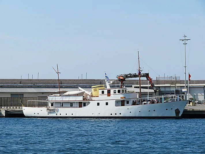 a large white boat in a harbor aboard DEIANEIRA Yacht for Sale