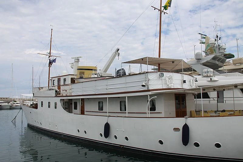 a large white boat in a harbor aboard DEIANEIRA Yacht for Sale