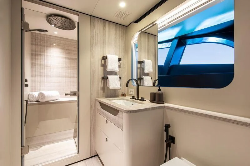a bathroom with a glass shower door aboard LL Yacht for Sale