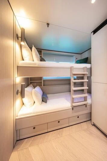 a bunk bed with a white shelf aboard LL Yacht for Sale