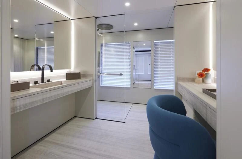 a modern bathroom with a large mirror aboard LL Yacht for Sale